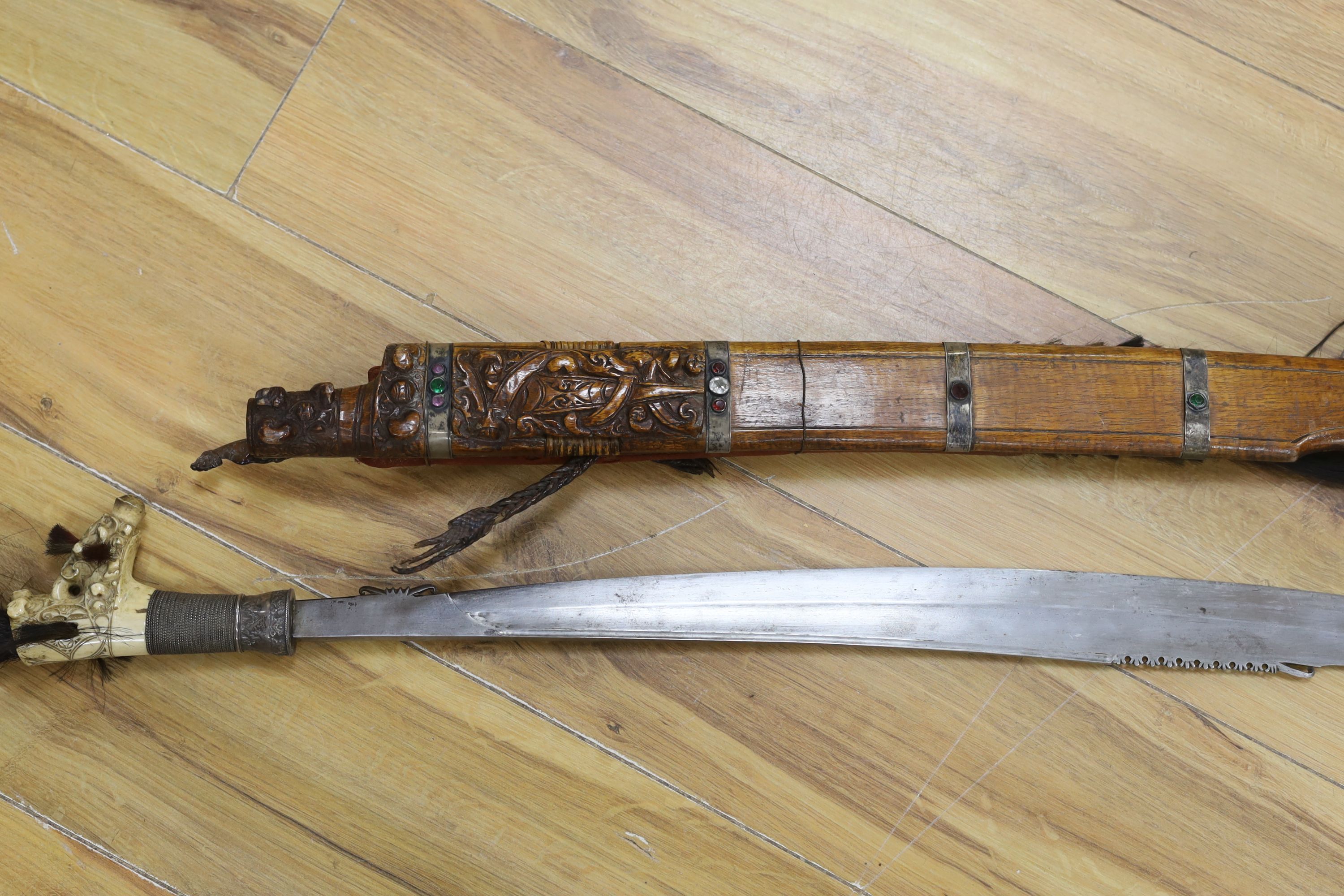A Borneo 'headhunter's sword', a bone carving and feather swot (3), sword 77 cm long